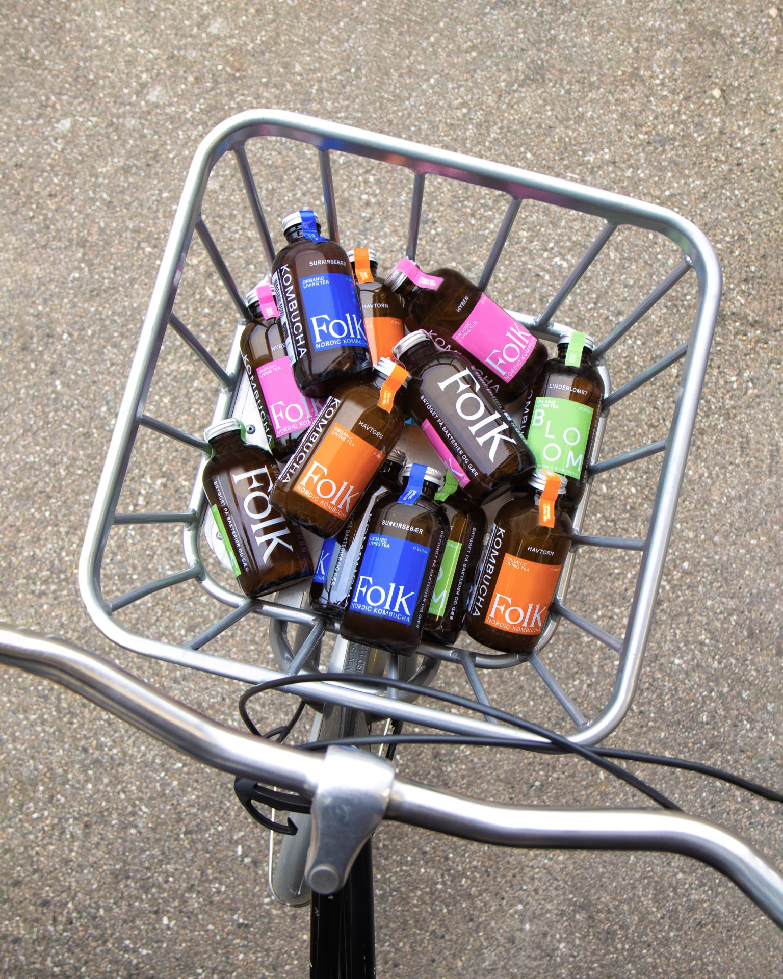 Bicycle basket full of Folk Kombucha bottles being delivered in Copenhagen